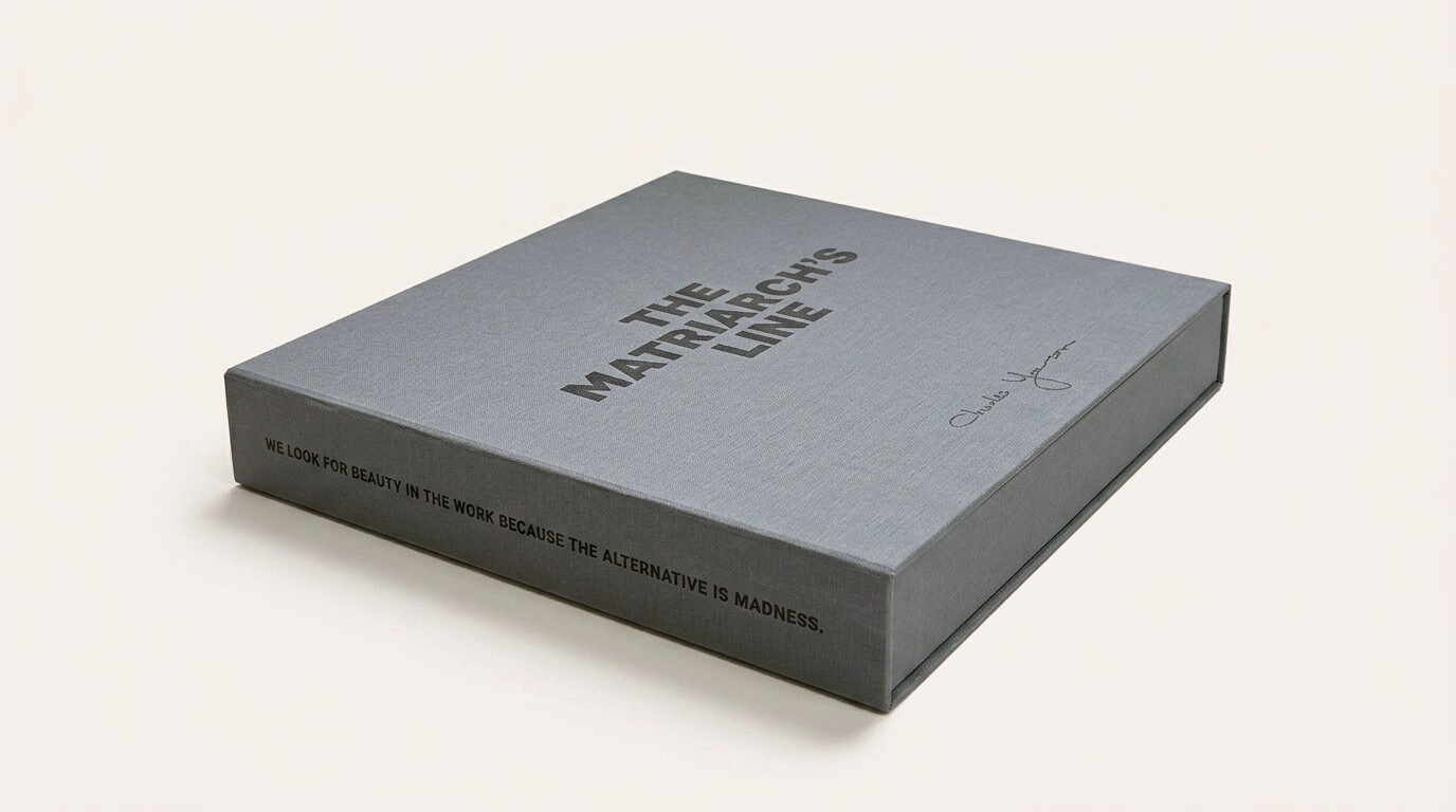 The Matriarch's Line Collector's Edition clamshell in 3/4 perspective, showing the foil-stamped title on the top face and the quote 'We look for beauty in the work because the alternative is madness' along the front spine.