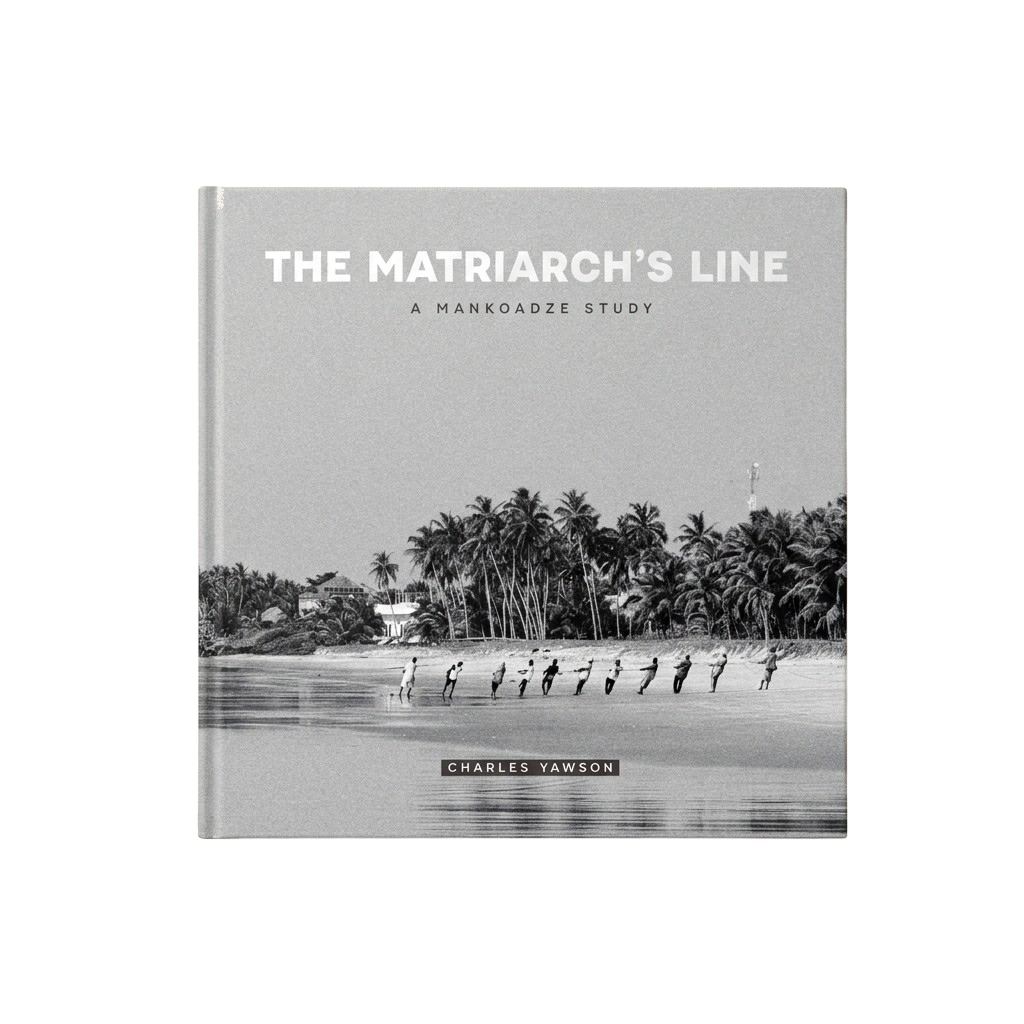 The Standard Edition of The Matriarch's Line photographed from directly above — the wraparound black-and-white photograph of palm trees over a line of net-haulers on a wet Mankoadze beach, foil-stamped title, and Charles Yawson's name at the bottom.